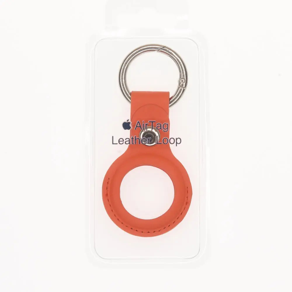 Estuche clásico de cuero naranja para AirTag, diseño abierto compatible con todos los modelos de Apple.