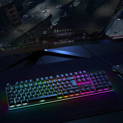 Gadget Aukey Gaming Kmg12 Mechanical Keyboard with customizable RGB backlighting on a gaming desk setup.